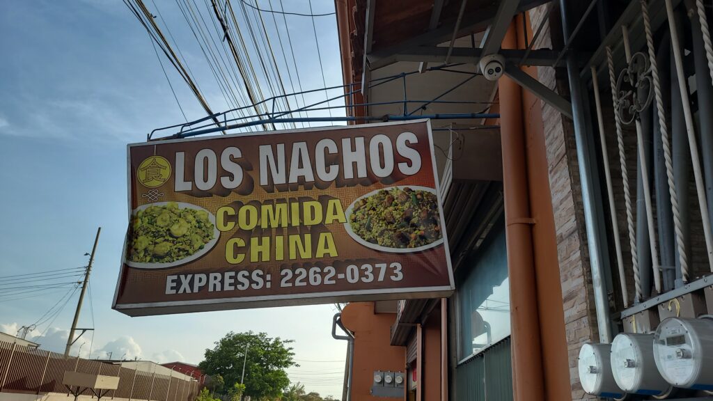 Restaurant sign for a restaurant called Los Nachos, offering Chinese food...